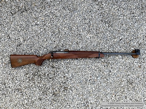 Full profile view of an Australian Sportco Omark Model 44 single-shot bolt-action target rifle with wooden stock 