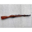 Left profile view of a Russian Mosin-Nagant M44 Izhevsk bolt-action carbine with wooden stock and bayonet folded 