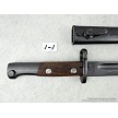 Detailed view of the riveted wooden handle scales and locking mechanism on a vintage Yugoslavian M48 Mauser bayonet 