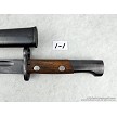 Detailed view of the riveted wooden handle scales and locking mechanism on a vintage Yugoslavian M48 Mauser bayonet 