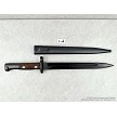 Original Yugoslavian M48 military surplus bayonets displayed next to its matching steel scabbard 