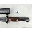 Detailed view of the riveted wooden handle scales and locking mechanism on a vintage Yugoslavian M48 Mauser bayonet 