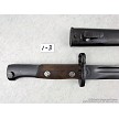 Detailed view of the riveted wooden handle scales and locking mechanism on a vintage Yugoslavian M48 Mauser bayonet 