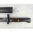 Detailed view of the riveted wooden handle scales and locking mechanism on a vintage Yugoslavian M48 Mauser bayonet 